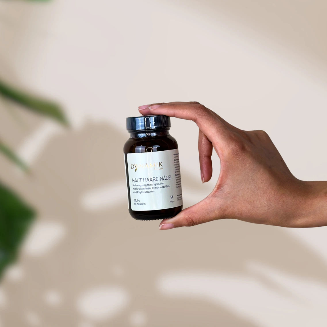 Brauner Glasbehälter mit DynamikPlus "Haut Haare Nägel" Etikett und schwarzem Drehverschluss